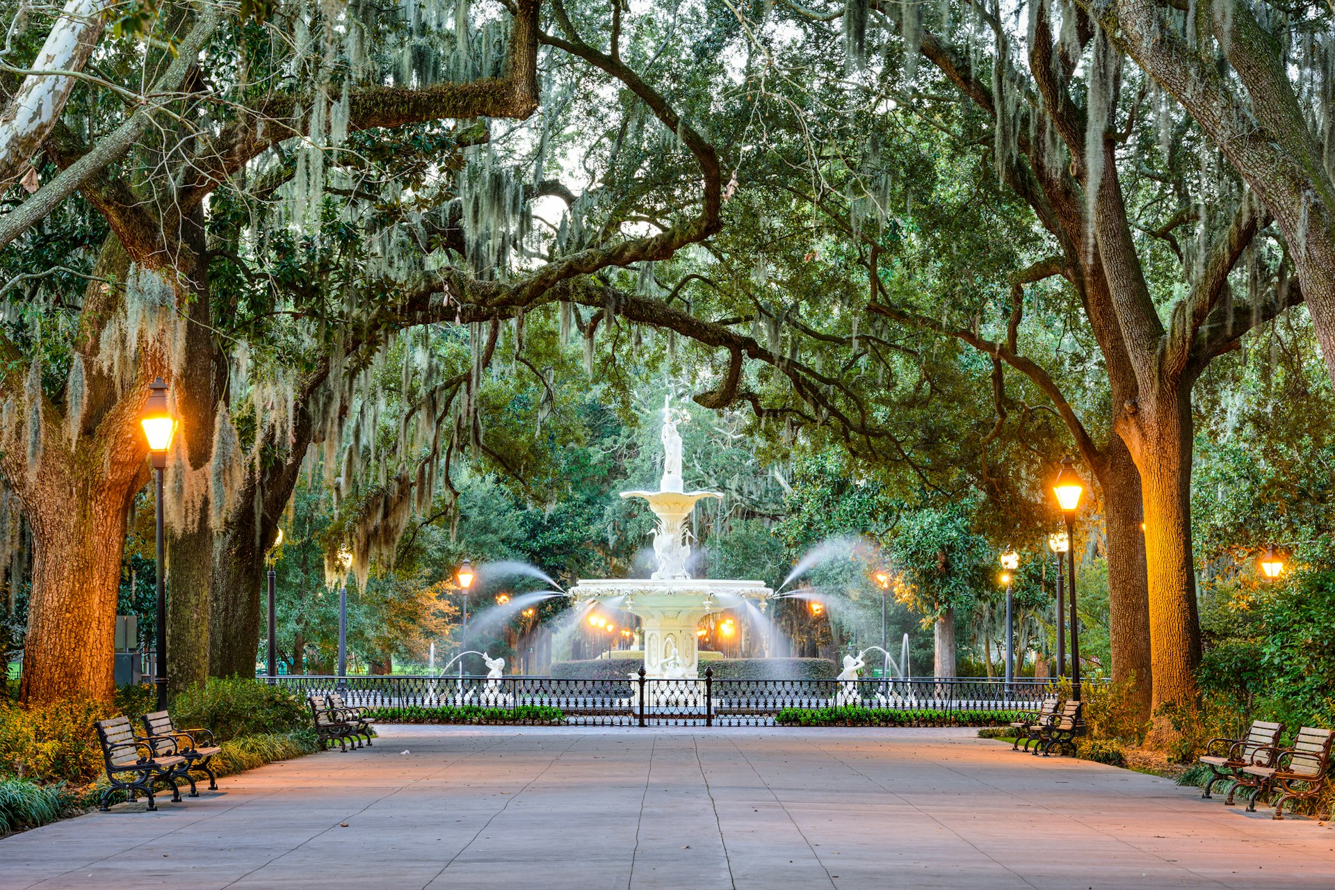 The famous white Forsyth Park fountain framed by an avenue of trees in Savannah